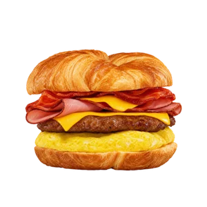 Fully loaded Croissan'wich - sausage bacon ham egg and cheese piled on a golden croissant